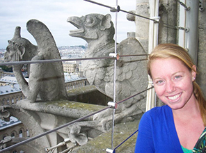 Photo of Meghan Wilcock by stone gargoyles on a building